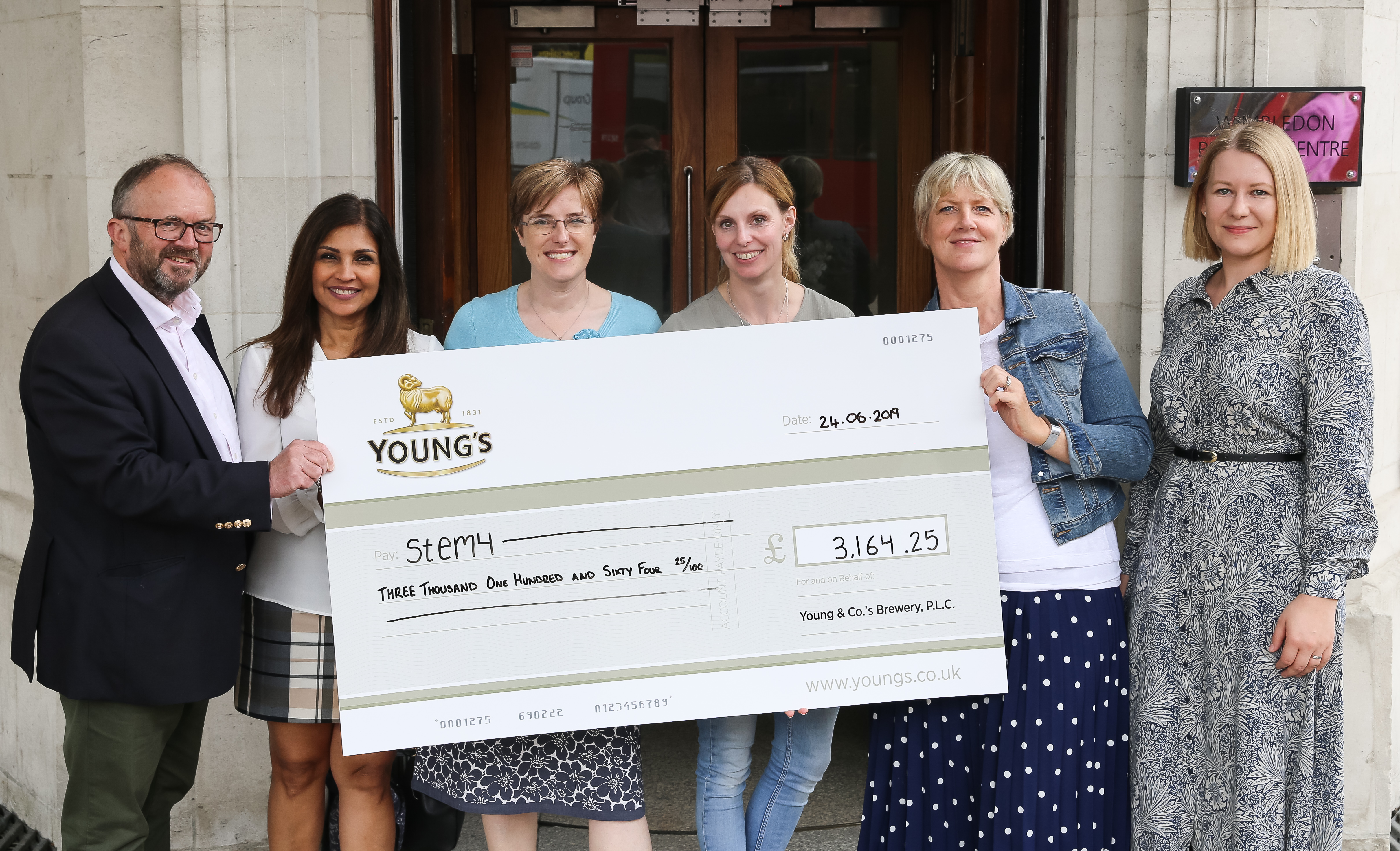 Youngs presenting a cheque to stem4